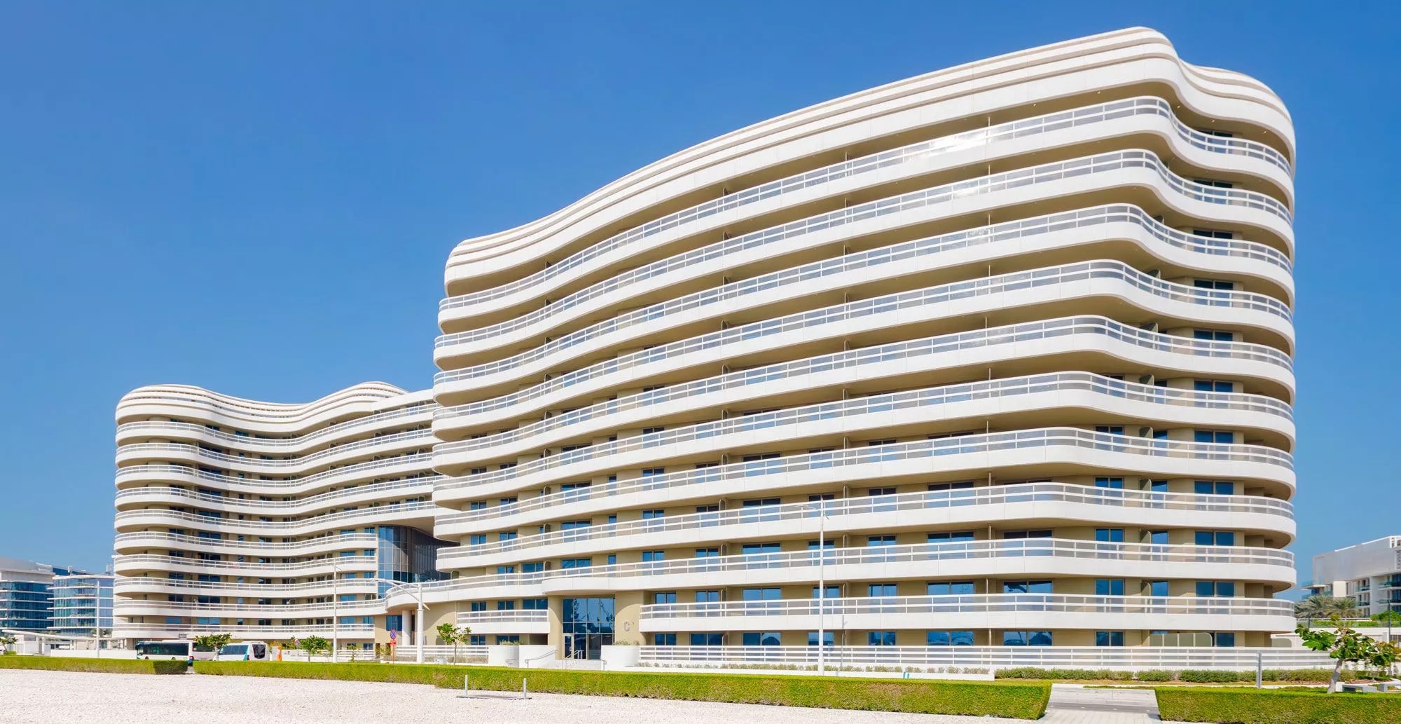 Photograph of the completed Ajwan Towers and their curved, wave-like façade