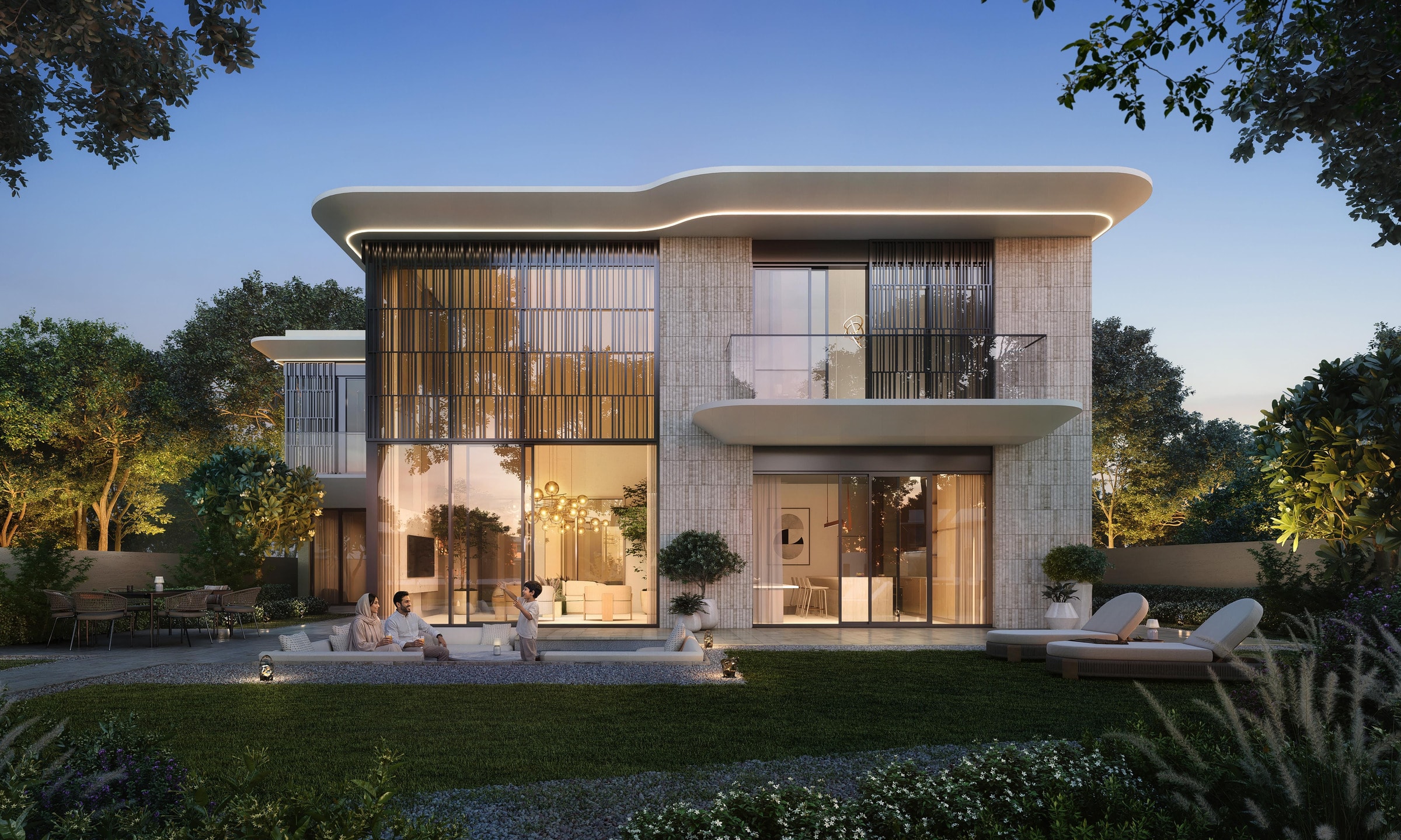 Talay-Villa in der Dämmerung mit geschwungener Dachkante, Natursteinfassade und beleuchtetem Wohnbereich zum Garten